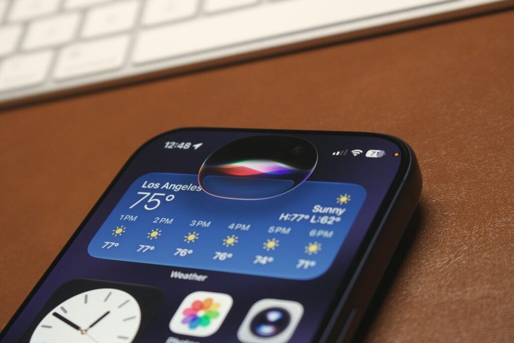 iPhone screen showing weather app and siri interface